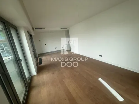 Empty unfurnished room with wooden flooring and large windows. - image 4