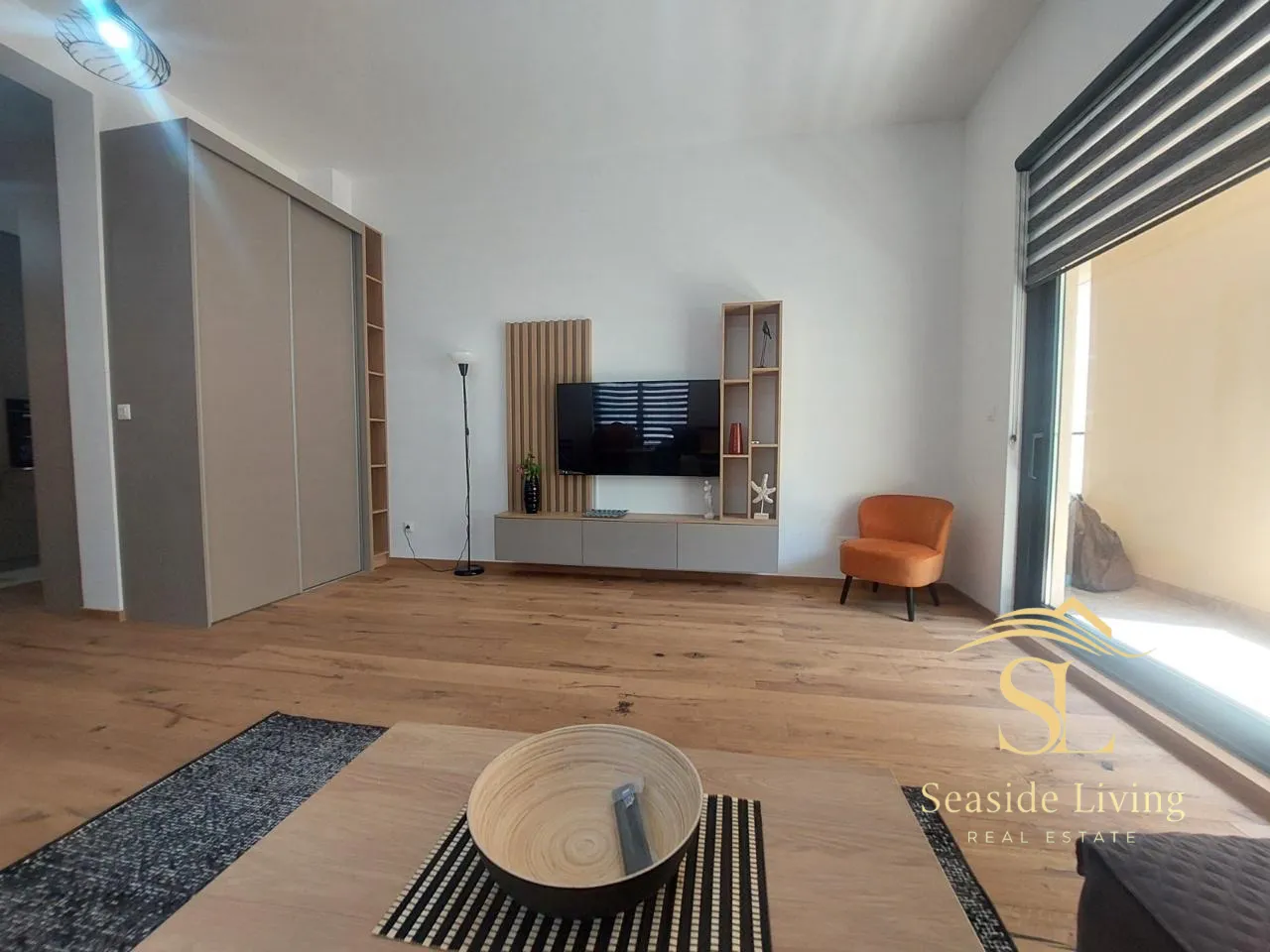 Modern living room with a TV unit and seating area.