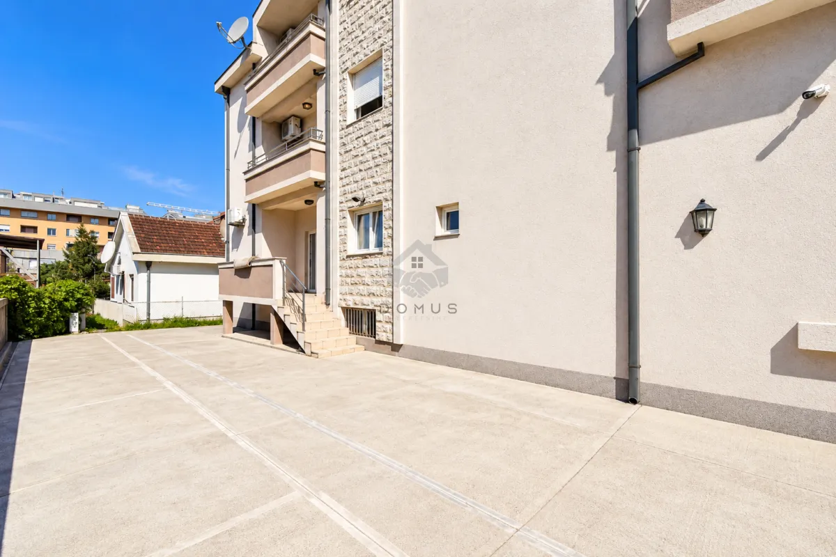 View of the exterior of the building and the concrete driveway.