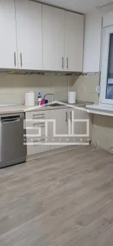 Small kitchen with light cabinets and a sink by the window. - image 5