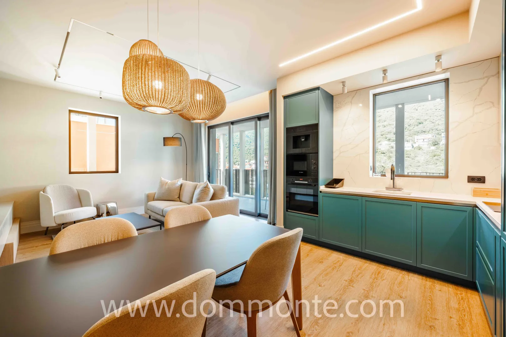 Modern living room with dining area and integrated kitchen.