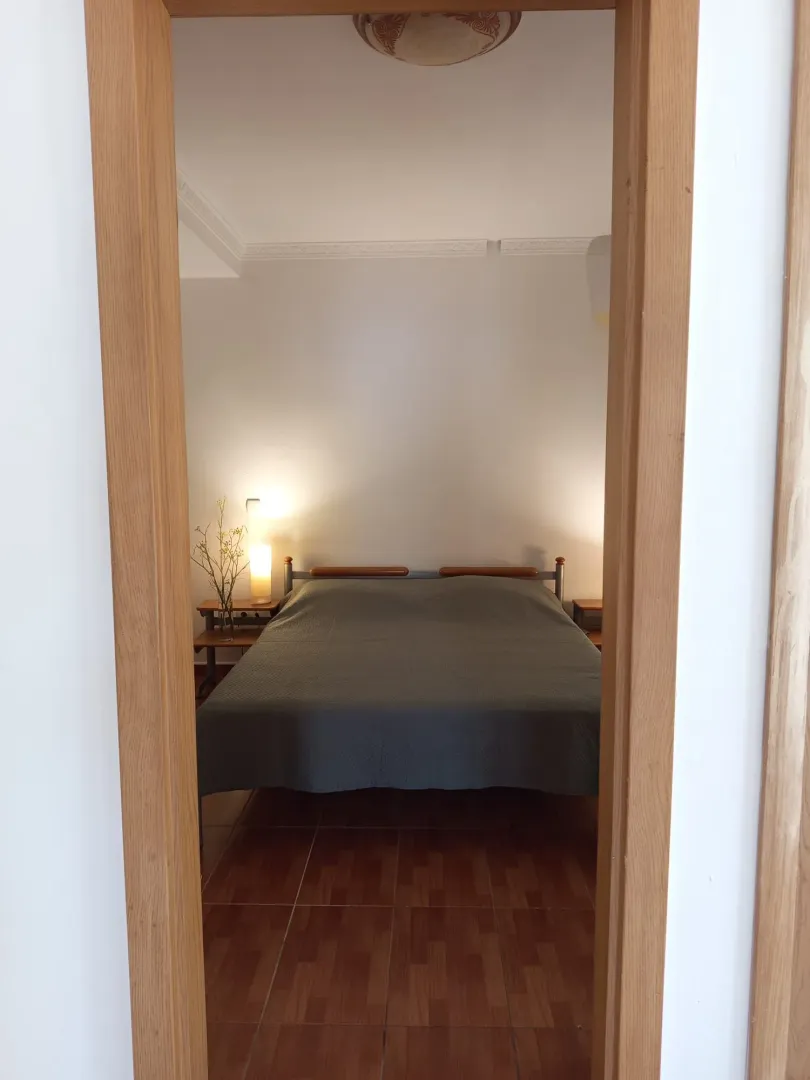 View through the doorway into a tidy bedroom with a double bed.