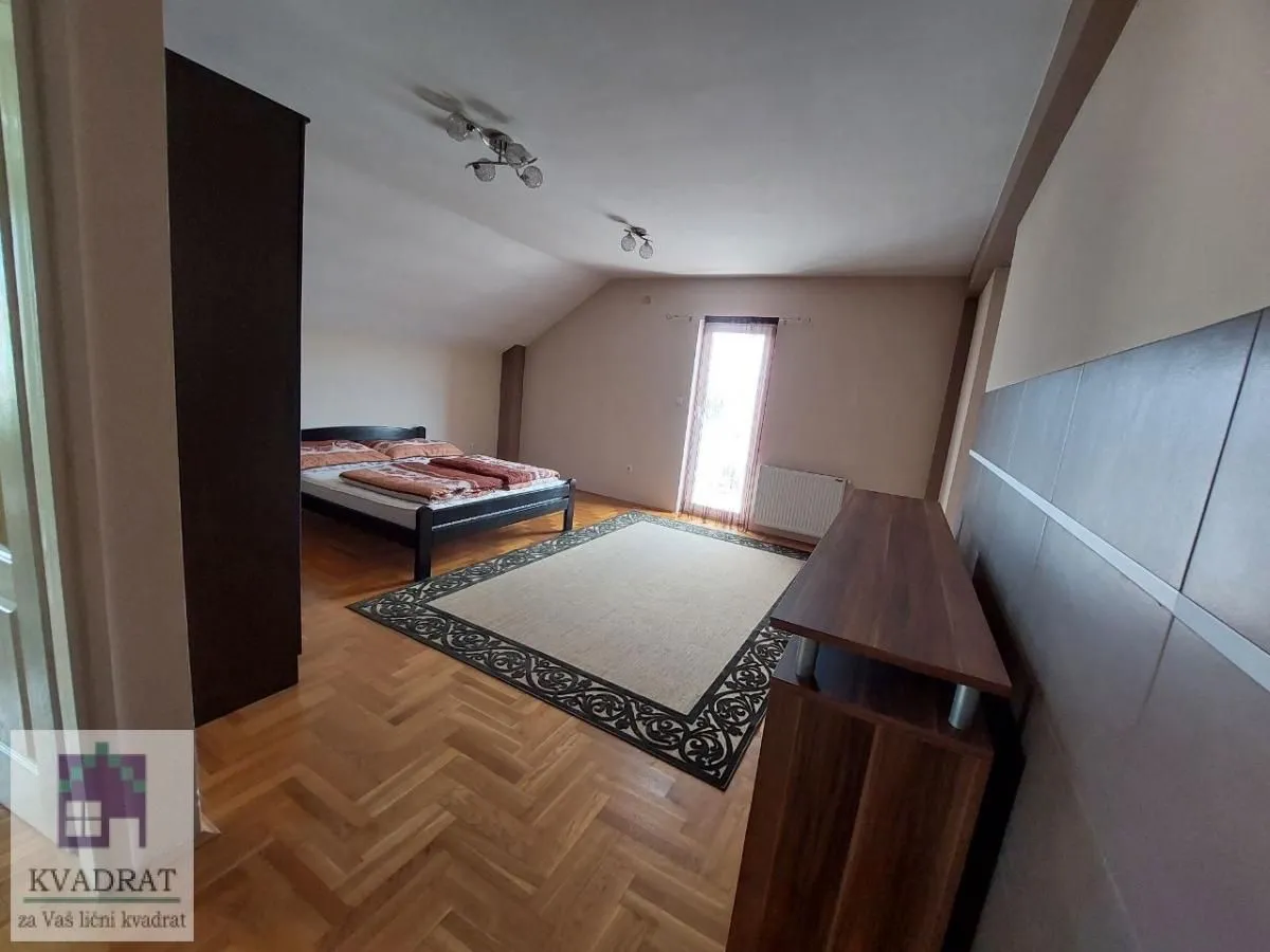 Bedroom with a double bed, parquet flooring, and access to the terrace.