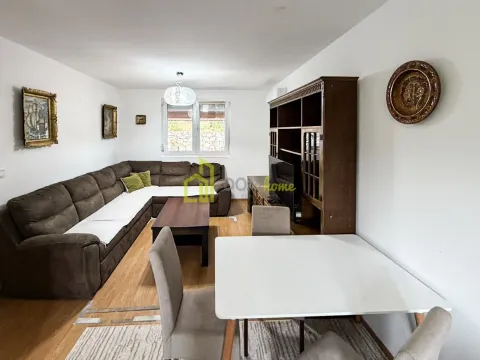 Living room with a sofa set, dining table and wooden furniture. - image 2
