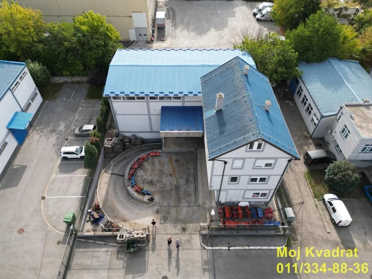 Aerial view of the commercial building with courtyard and parking.