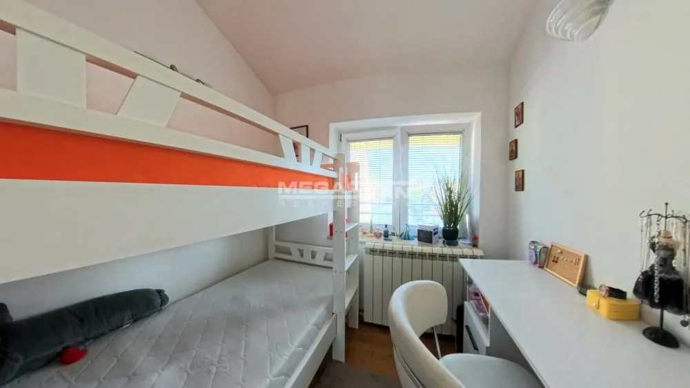 Dečja soba sa krevetom na sprat i radnim stolom.