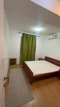 Bedroom with a double bed, green curtains, and an air conditioner. - image 5
