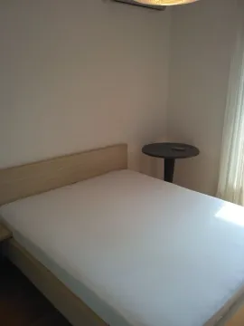 Bright bedroom with a double bed and a side table. - image 6
