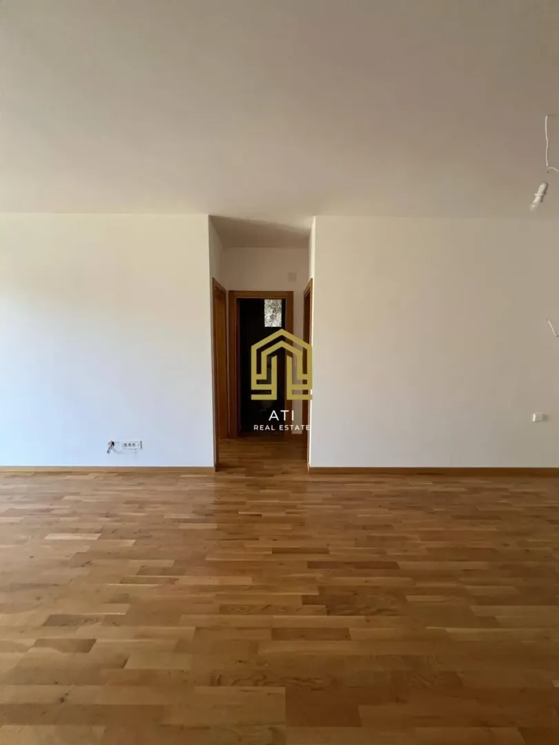 Empty room with wooden flooring and agency watermark.