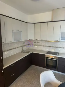 Kitchen equipped with lower and upper cabinets, built-in oven, and hob. - image 9
