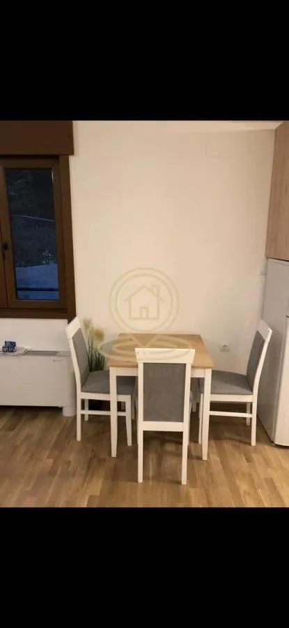 Dining table with four chairs in a bright interior.