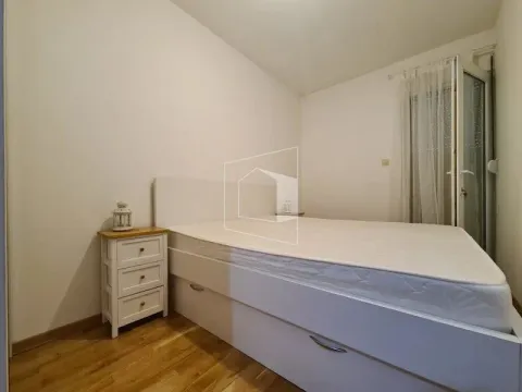 Bright bedroom with a white bed, nightstand, and terrace access. - image 8