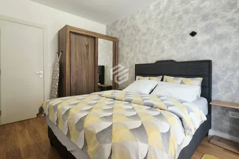 Furnished bedroom with a double bed and a wooden wardrobe. - image 8