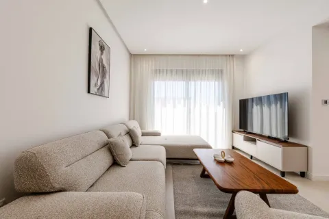 Modern and bright living room with a sectional sofa and a TV. - image 15