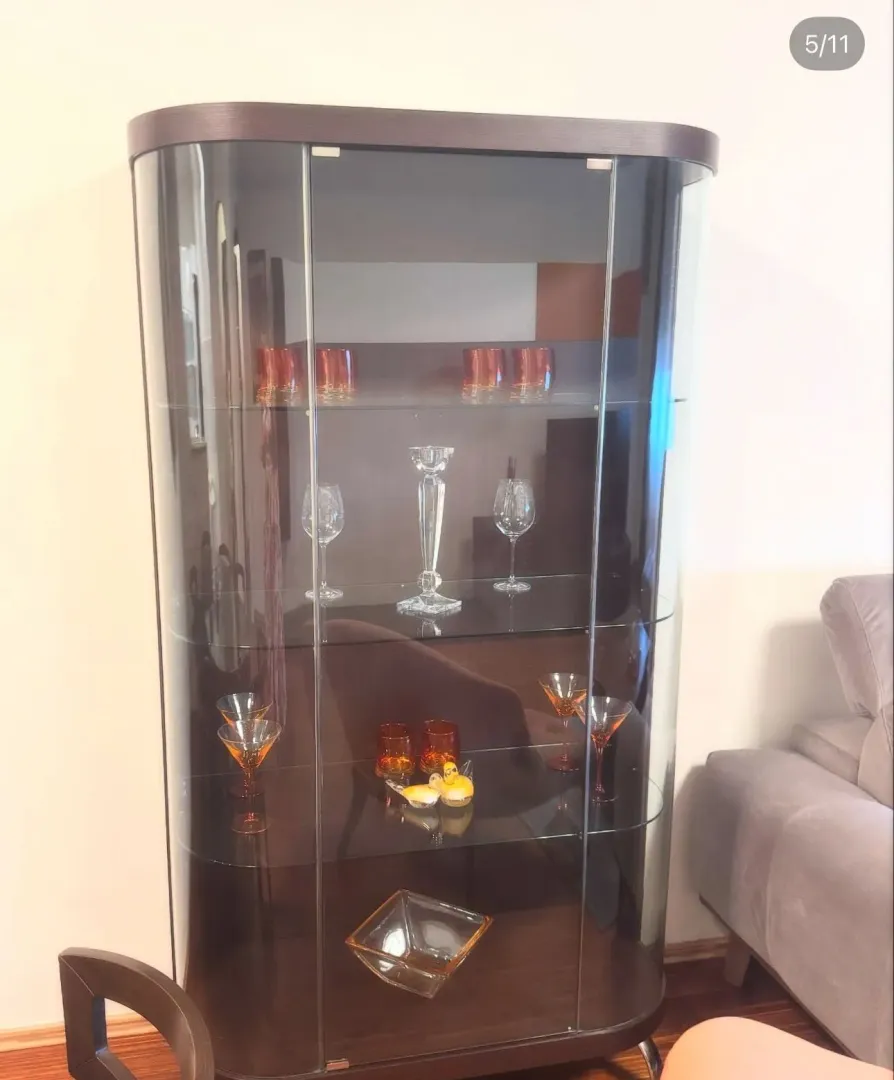Dark glass display cabinet in the living room.
