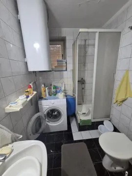 Kupatilo opremljeno tuš kabinom, umivaonikom, wc šoljom i mašinom za veš. - image 9