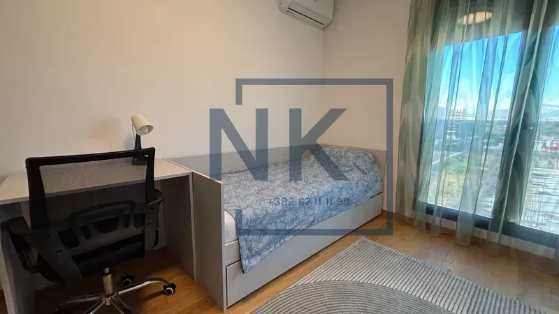 Children's bedroom with a bed, desk, and air conditioning.