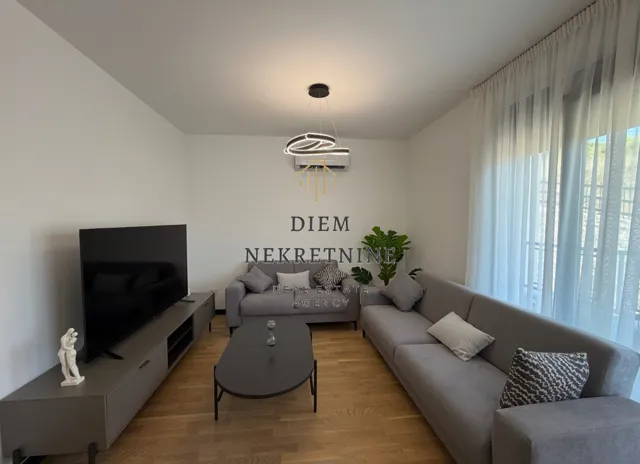 Living room with a sofa set, television, and coffee table.