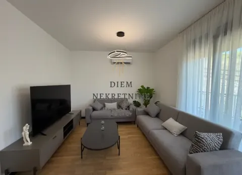 Living room with a sofa set, television, and coffee table. - image 2