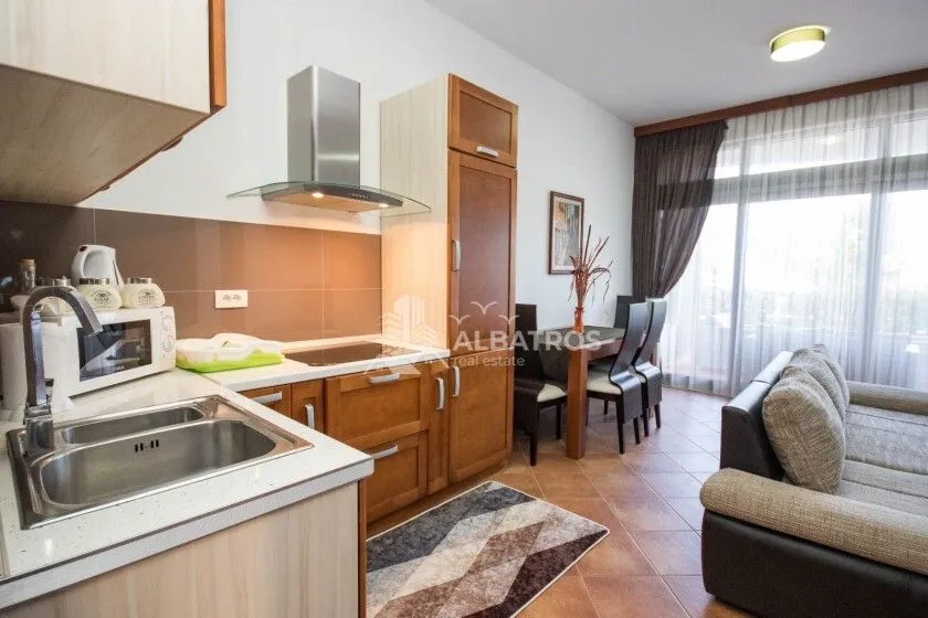 Open-plan space with a kitchen, dining area, and living room.