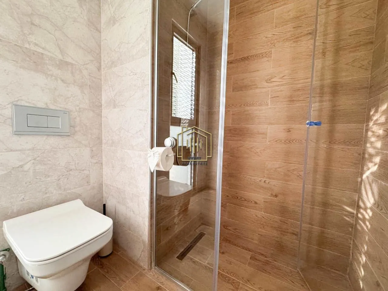 Modern bathroom with a walk-in shower and a wall-mounted toilet.