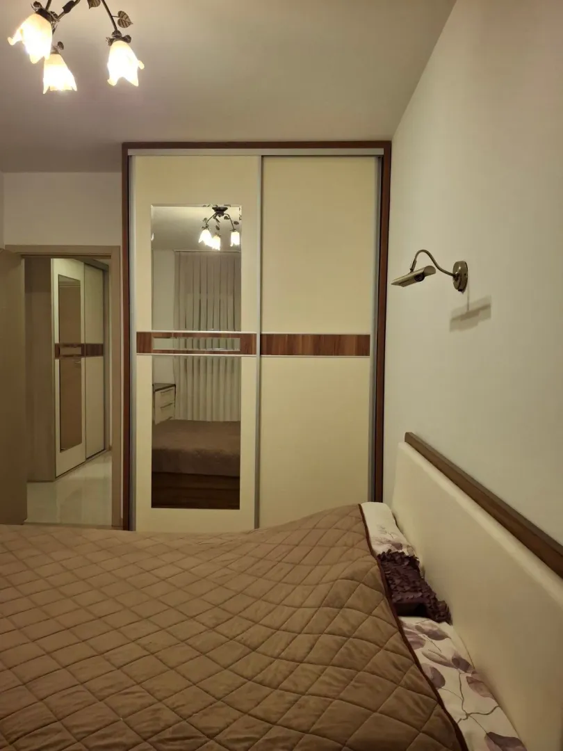 Furnished bedroom with a large wardrobe and a double bed.