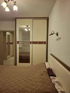 Furnished bedroom with a large wardrobe and a double bed. - image 13
