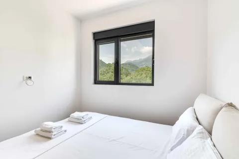 Bright bedroom with a double bed and nature view. - image 12