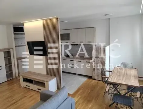 Living room connected to the dining area and kitchen. - image 2