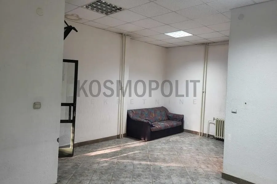 Empty room with a sofa and tiled floor.