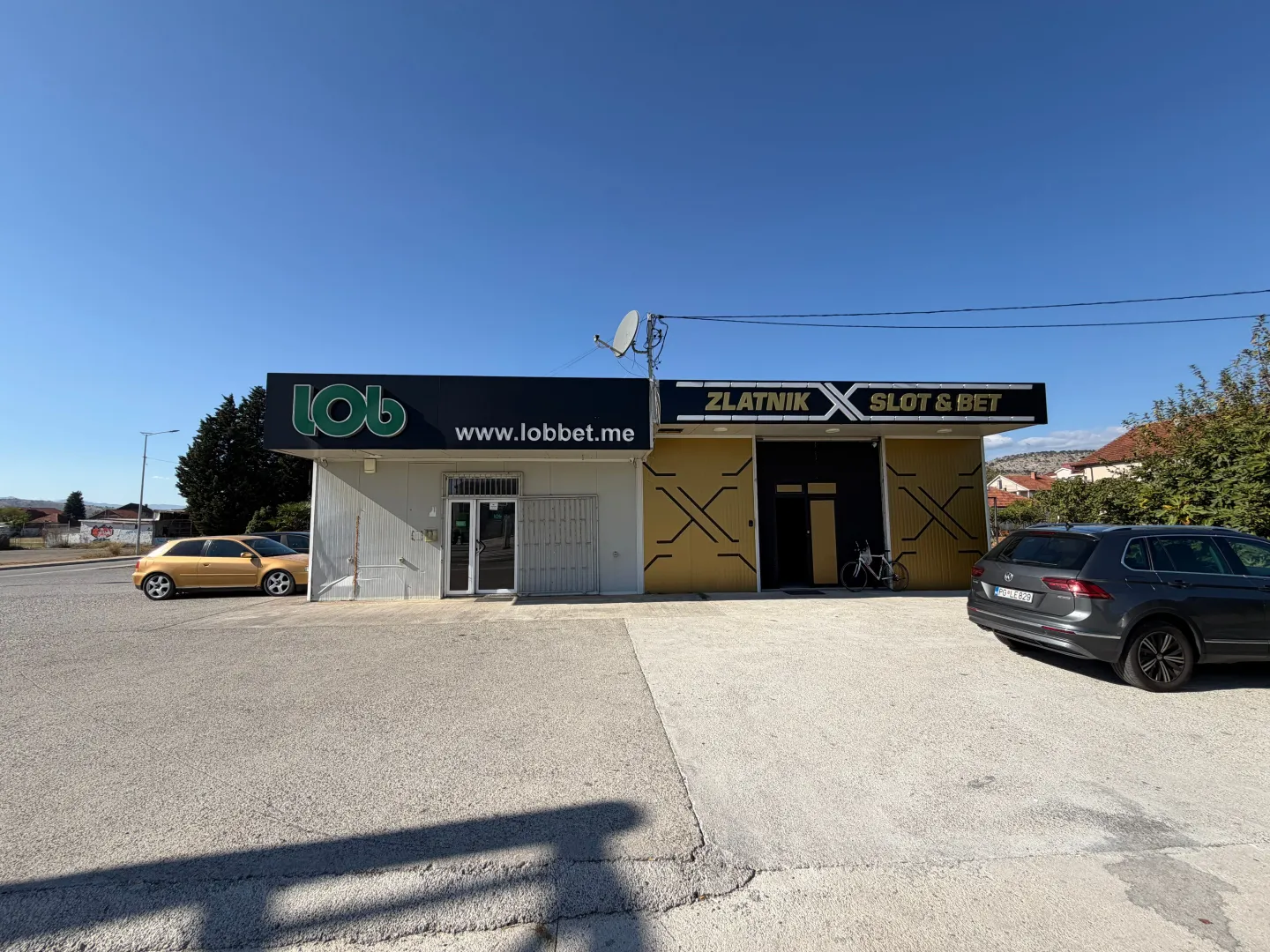Exterior of a commercial building with parking and entrance.