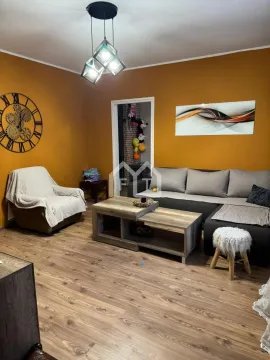 Living room with a sofa, an armchair, and a wooden coffee table. - image 6