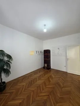 Empty room with parquet flooring and a wood-burning stove. - image 3
