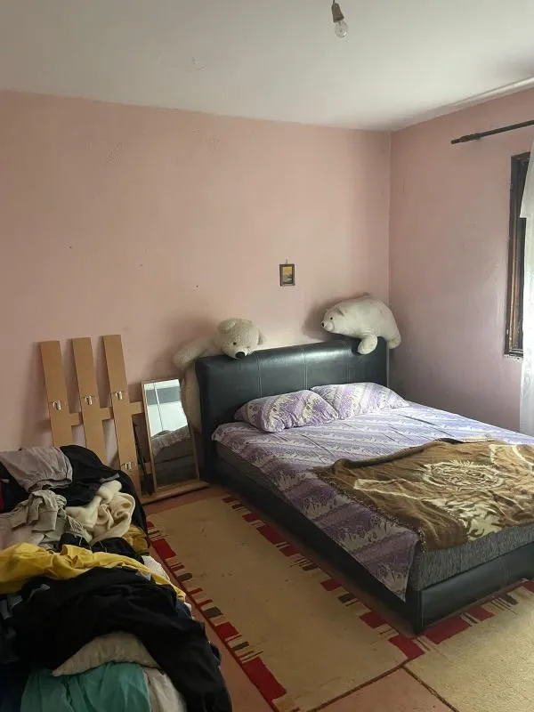 Bedroom with a double bed and soft toys.