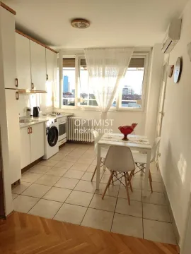 Kitchen with a dining area and white cabinetry. - image 7