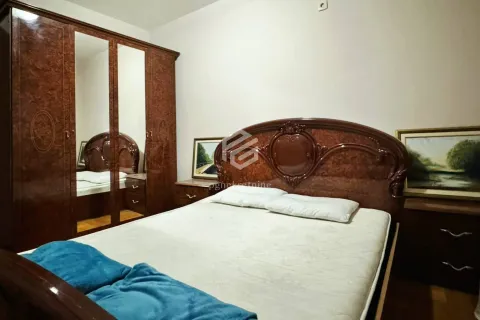 Bedroom with a double bed and a wooden wardrobe with a mirror. - image 10