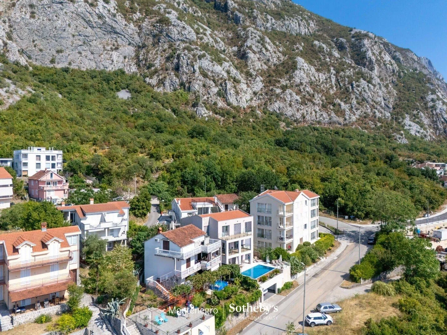 Pogled iz vazduha na stambene zgrade u podnožju planine.