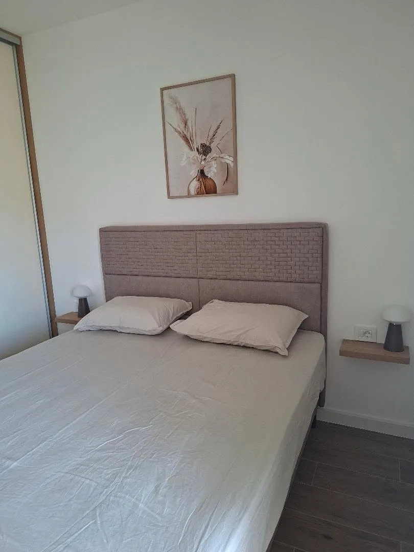 A bedroom with a double bed and bedside tables.