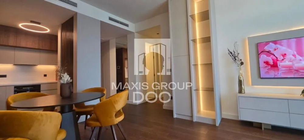 Modern living room with a dining area and kitchen in the background.