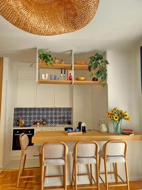 Modern kitchen with a bar counter and bar stools.
