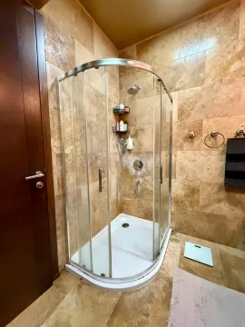 Bathroom with a shower cabin tiled in beige tiles. - image 2