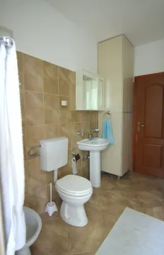 Bathroom equipped with sanitary fixtures, a sink, a cabinet, and a bidet. - image 7
