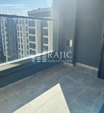 Modern terrace with tiles and a glass railing. - image 5
