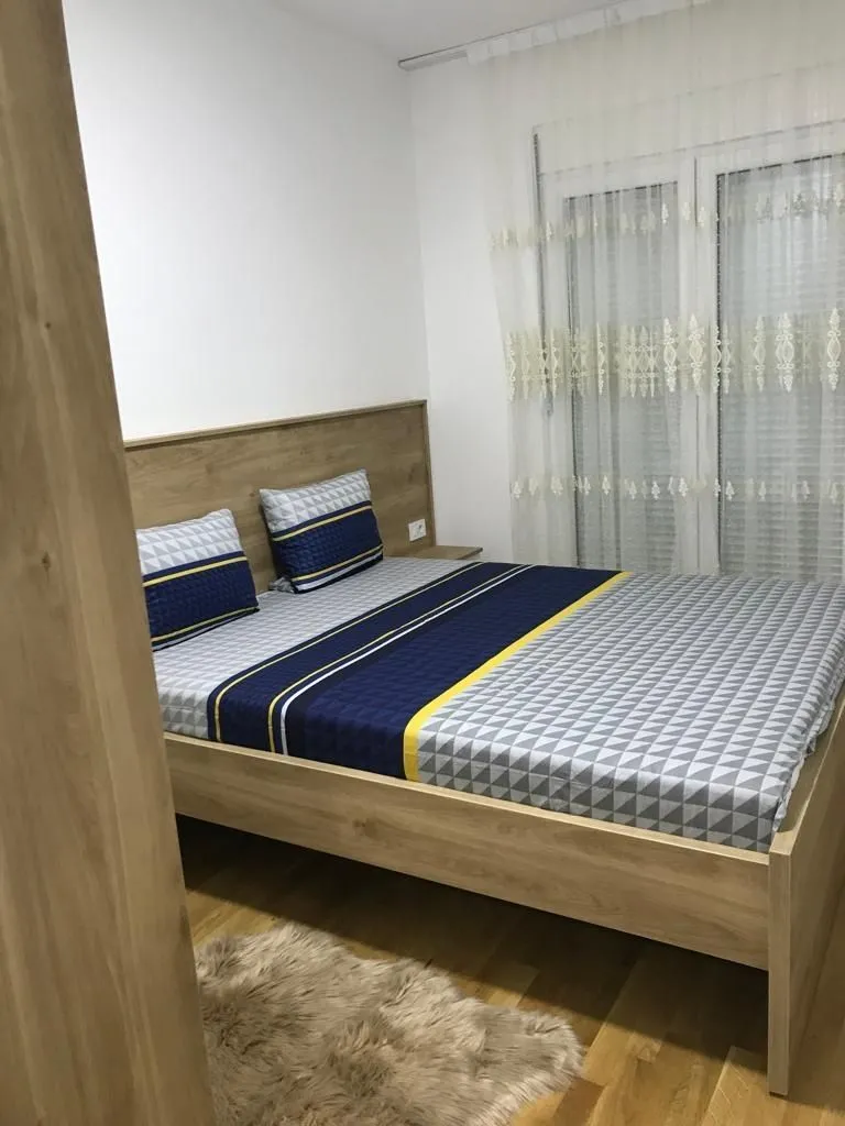 Bright bedroom with a wooden bed.