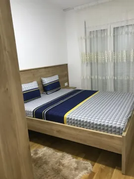Bright bedroom with a wooden bed. - image 4