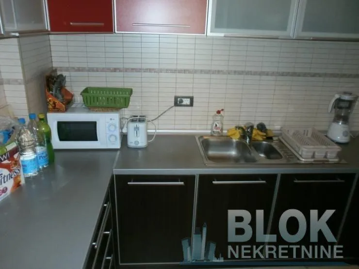 View of part of the kitchen with work units, sink, and home appliances.