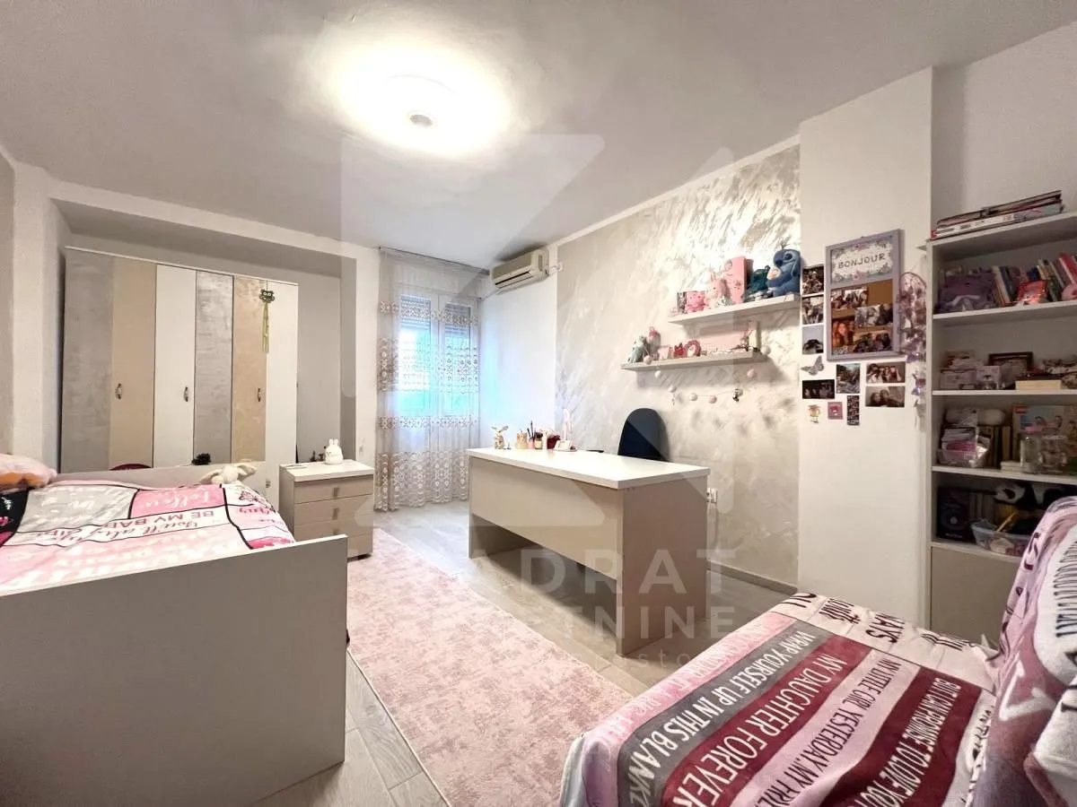Children's bedroom with a bed, desk, and wardrobe.