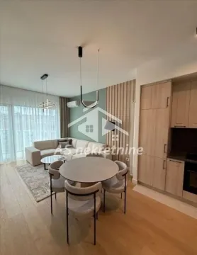 Open-plan living room with dining area and kitchen. - image 3