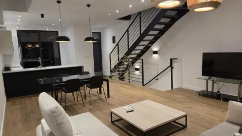 Modern living room with dining area, kitchen and staircase. - image 5