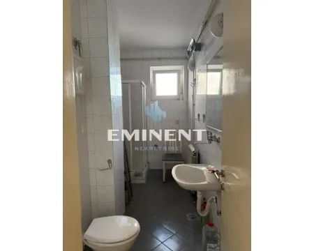 Smaller bathroom with a shower cabin, washbasin, and toilet. - image 9